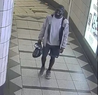 Craig Anderson walks through a train station.