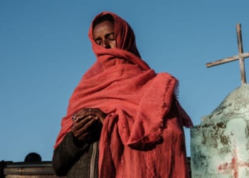 A refugee prays at an Ethiopian Orthodox Church building in eastern Sudan on Dec. 6, 2020.