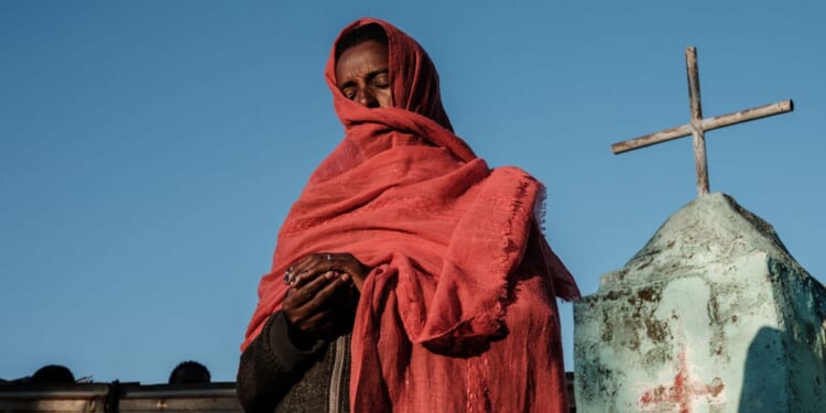 A refugee prays at an Ethiopian Orthodox Church building in eastern Sudan on Dec. 6, 2020.