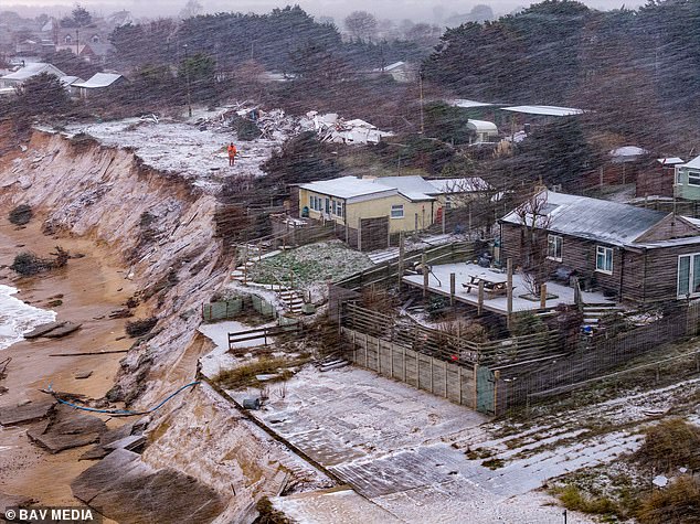 .Fourteen clifftop homes have been warned their properties are at risk of imminent collapse