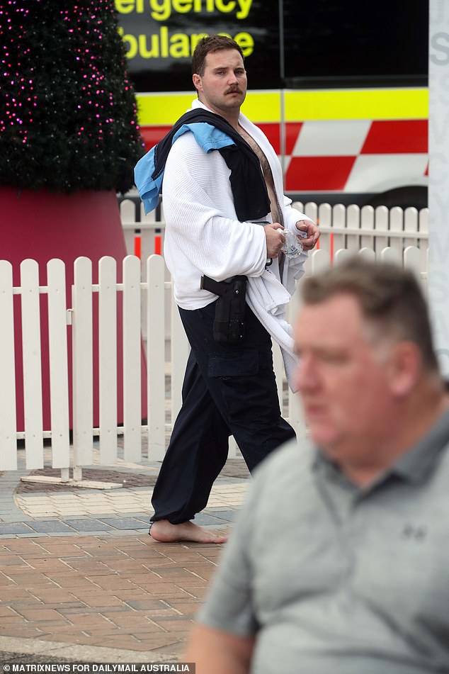 The hero cop is seen after he charged into the surf at Coogee Beach in his full uniform