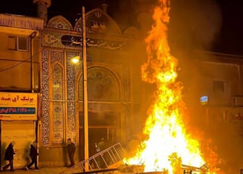 Debris burns outside a religious centre in the city of Gorgan