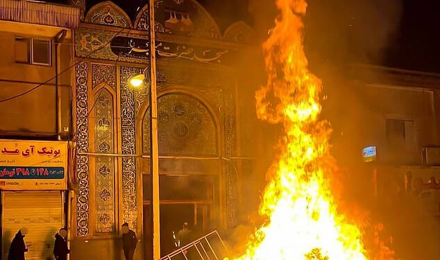 Debris burns outside a religious centre in the city of Gorgan