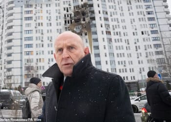 Defence Secretary John Healey meets emergency service workers at the scene of last night's drone attack in Kyiv