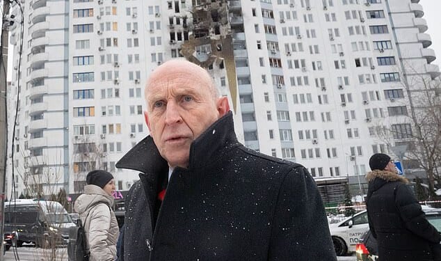 Defence Secretary John Healey meets emergency service workers at the scene of last night's drone attack in Kyiv