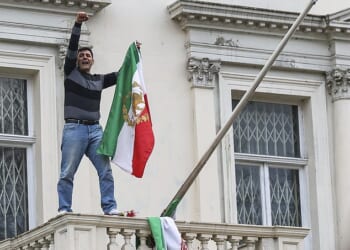 In London on Saturday a male protester was seen climbing onto the balcony of the Iranian embassy in Kensington and tearing down the flag of the current regime