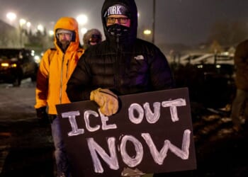 A protester holding an anti-ICE Sign standing outside the Henry Bishop Whipple Federal building on Jan. 18, 2026 in Minneapolis, Minnesota.