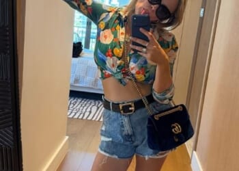 Emily Atack's dramatic transformation continued as she showed off her tummy in a cropped floral shirt and denim shorts during a South African getaway on Tuesday