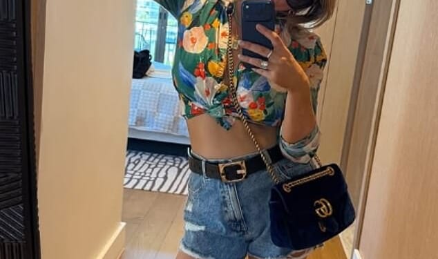 Emily Atack's dramatic transformation continued as she showed off her tummy in a cropped floral shirt and denim shorts during a South African getaway on Tuesday