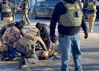 Male nurse Alex Pretti lies on the ground after being shot dead, surrounded by ICE agents