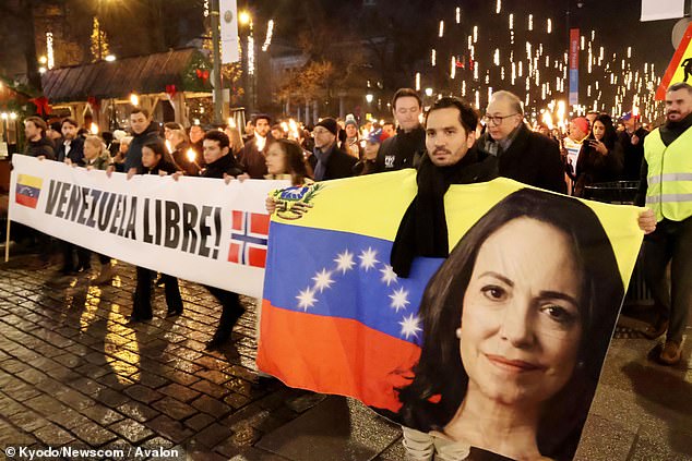 People take part in a parade celebrating Venezuelan opposition leader Maria Corina Machado receiving the Nobel Peace Prize