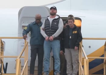 Stunning new footage has emerged of Ryan Wedding arriving in the US in handcuffs