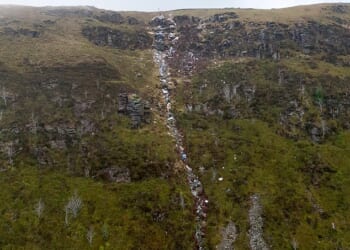 Farmer Katie Davies, 40, is losing sleep in frustration over the river of garbage that has been dumped on her land (pictured)