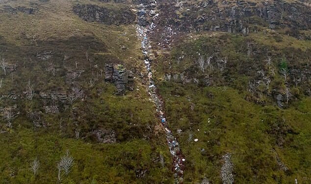 Farmer Katie Davies, 40, is losing sleep in frustration over the river of garbage that has been dumped on her land (pictured)