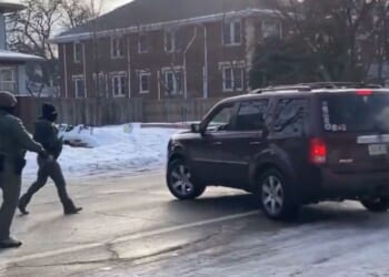 The officers are seen approaching the vehicle to confront the driver.