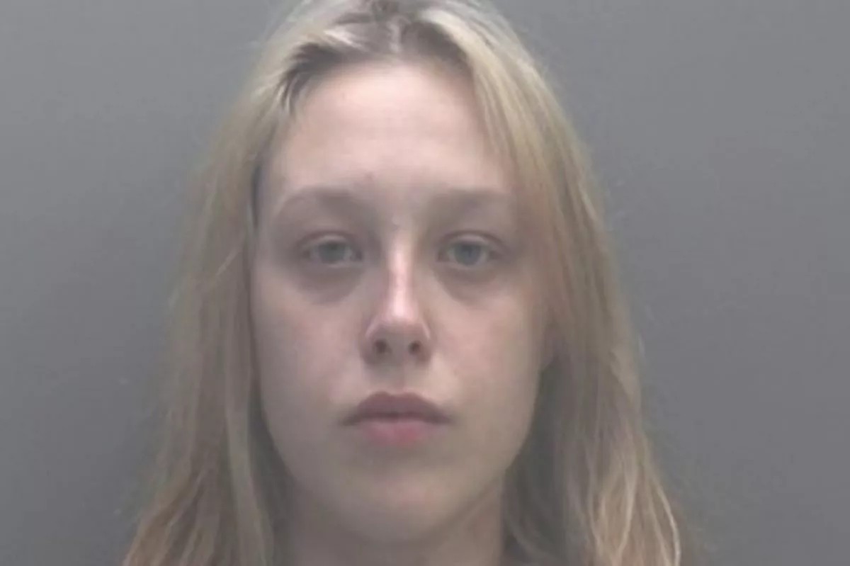 A young woman with long blonde hair looks directly at the camera.