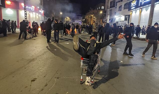 Anti-regime demonstrators celebrate as they take control of the streets in the city of Kermanshah, western Iran, this week as protests sweep the nation