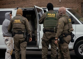 People detained earlier in the day are taken to a parking lot on the far north side of the city before being transferred to an Immigration and Customs Enforcement facility on Oct. 31, 2025, in Chicago, Illinois.