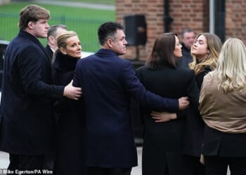 Gabby Logan and Kenny Logan with son Reuben McKerrow Logan (left) and daughter Louis (second from right) hold each other ahead of the service for the BBC presenter's father Terry Yorath