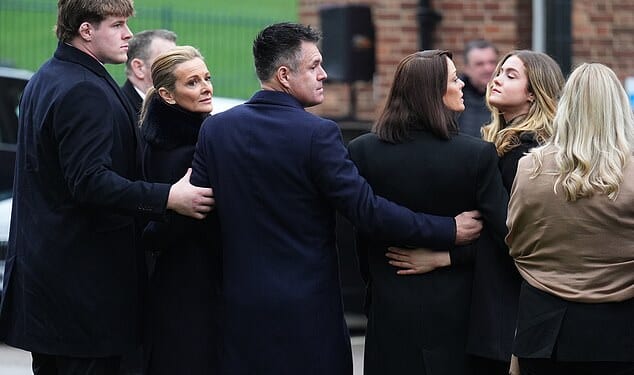 Gabby Logan and Kenny Logan with son Reuben McKerrow Logan (left) and daughter Louis (second from right) hold each other ahead of the service for the BBC presenter's father Terry Yorath