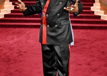 Pajama vibes! Snoop Dogg looked like he was going to an entirely different even as he sported a black satin suit on the Globes red carpet. The suit featured red stripe detailing on the blazer and side of his pants. He completed the look with a shiny black pair of dress shoes