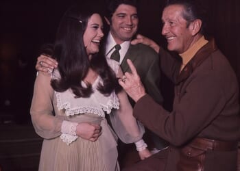 Singer Guy Hovis has died at age 84 after battling an illness in the hospital; Hovis pictured center with then-wife Ralna English and Lawrence Welk