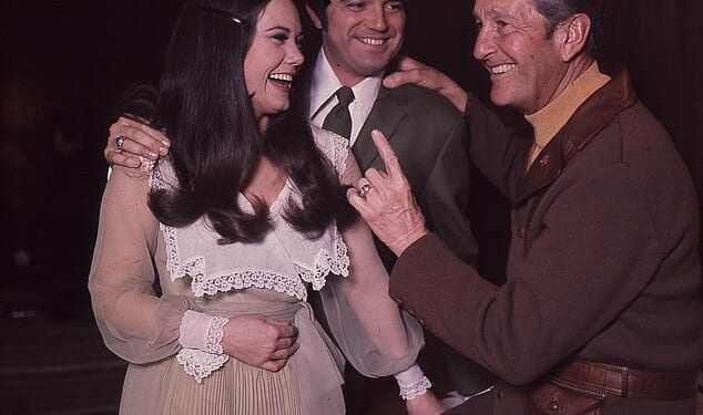 Singer Guy Hovis has died at age 84 after battling an illness in the hospital; Hovis pictured center with then-wife Ralna English and Lawrence Welk