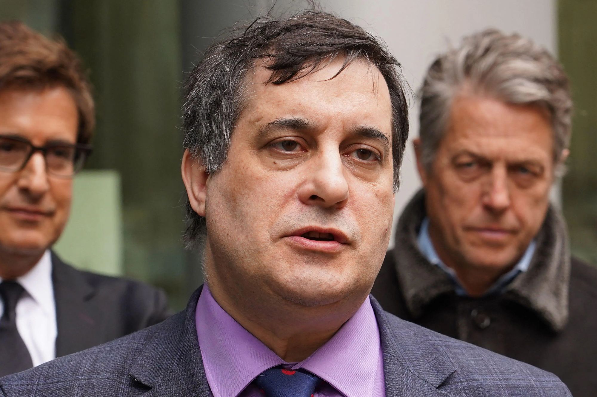 An image collage containing 1 images, Image 1 shows Hugh Grant and David Sherborne outside the Rolls Building in London