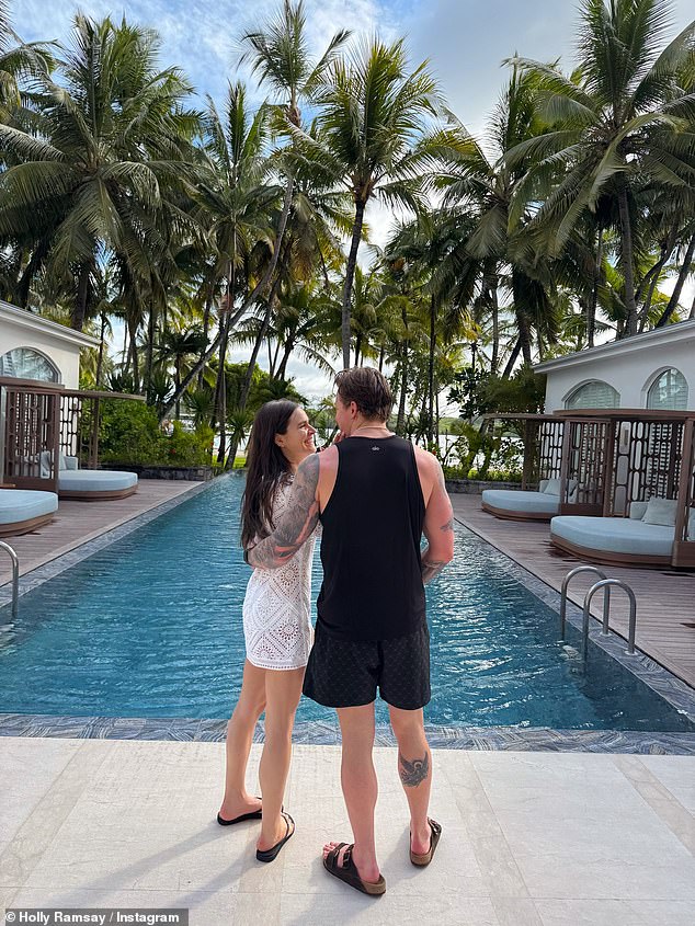 The influencer, 26, took to Instagram to show off her toned figure in a green bikini and Miu Miu hat as she posed near the beach before cosying up to her husband