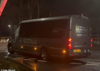 A blacked-out mini van with a police escort driven into a migrant camp in the early hours of Thursday morning