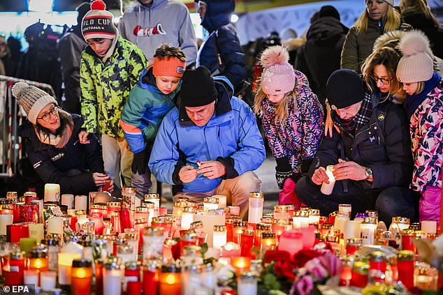 Visitors stood in sub zero temperatures watching the tributes, flowers and candles be laid out