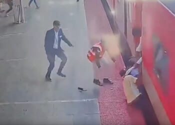 Horrifying moment father and young son are dragged by moving train as desperate onlookers try to rescue them