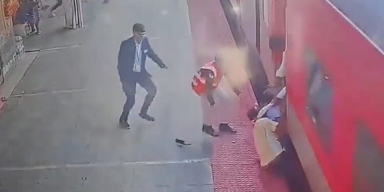 Horrifying moment father and young son are dragged by moving train as desperate onlookers try to rescue them