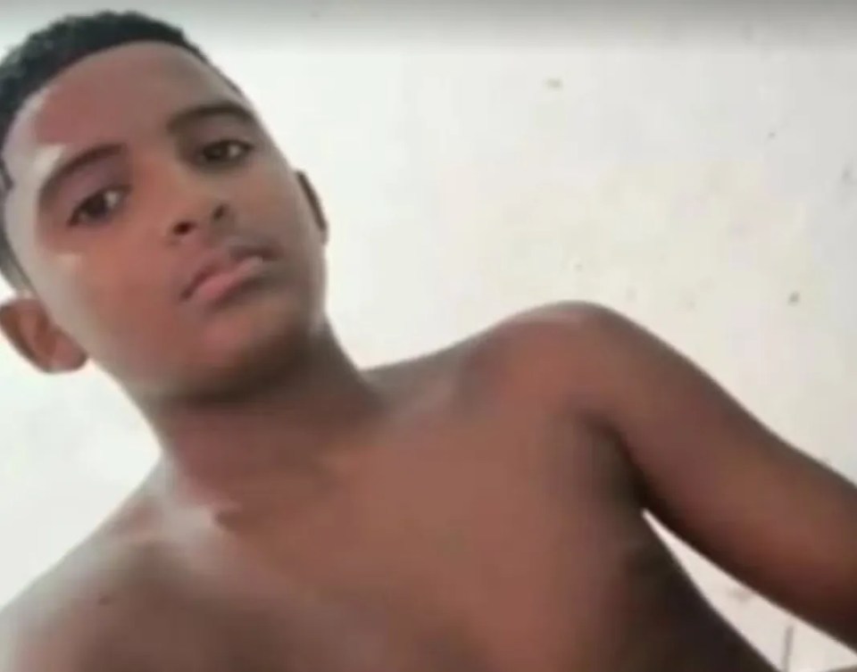 A young boy with short, dark hair and dark eyes looks forward at the camera.