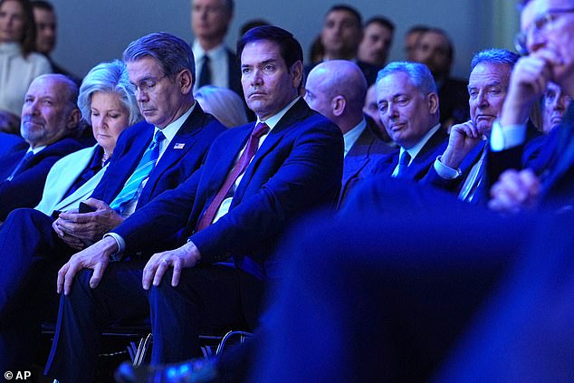 US Secretary of State Marco Rubio (center), sits with U.S. Treasury Secretary Scott Bessent  (third left) and White House chief of staff Susie Wiles (second left), as they listen to Trump's lengthy speech