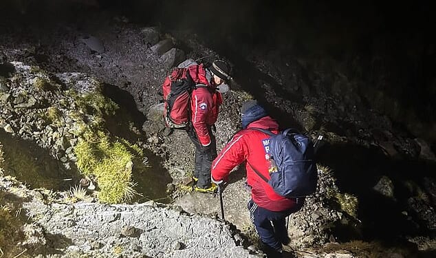 A mountain rescue team helped two young men who became stuck on Scafell Pike in 'treacherous conditions'