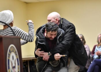 A man is tackled after spraying an unknown substance at Rep. Ilhan Omar during a town hall she was hosting in Minneapolis, Minnesota, on Jan. 27, 2026.
