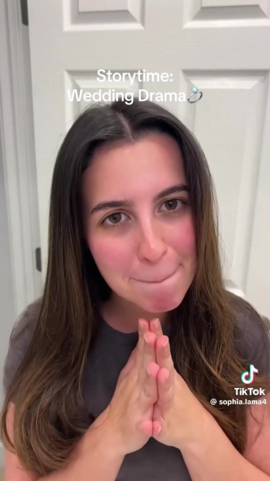 A woman with long dark hair, wearing a grey t-shirt, holds her hands together under her chin as if in prayer, looking at the camera. Text overlay reads "Storytime: Wedding Drama" with a ring emoji.