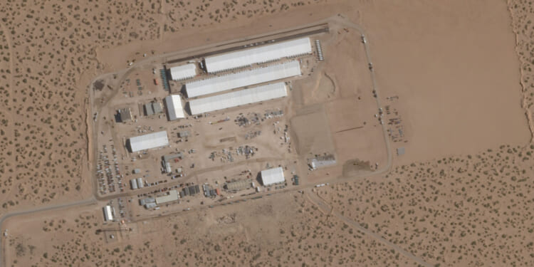 This Aug. 7, 2025, satellite image shows construction of large white tents for a new immigrant detention center at Fort Bliss, a U.S. Army base outside El Paso, Texas.