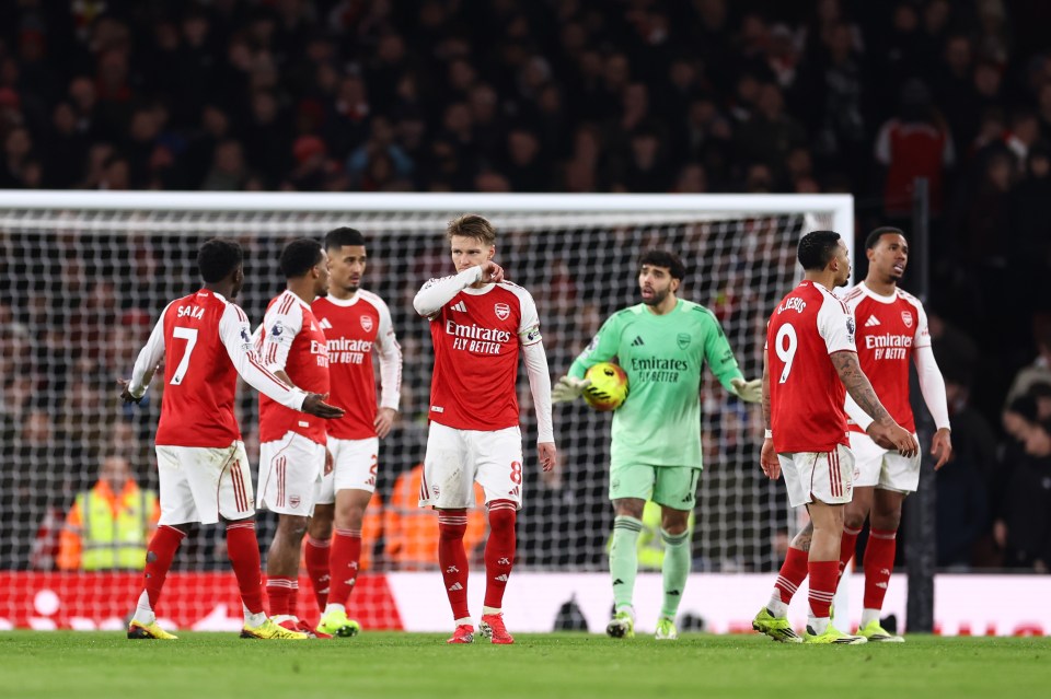 Arsenal players react after conceding a goal during the Premier League match against Manchester United.