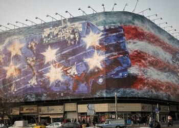 A billboard depicting a damaged US aircraft carrier with disabled fighter jets on its deck and a sign reading in Farsi and English, 'If you sow the wind, you'll reap the whirlwind,' is seen at Enqelab-e-Eslami (Islamic Revolution) Square in Tehran, Iran, Sunday, January 25