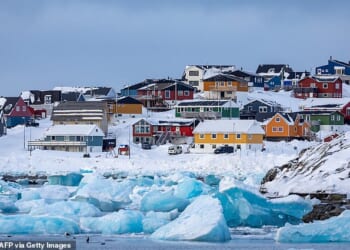 Colorful houses line the snowy coast of Nuuk, the capital city of Greenland. The city has a population of around 20,000