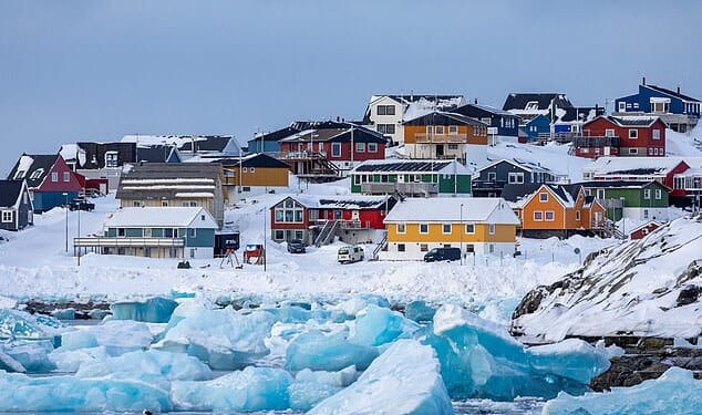 Colorful houses line the snowy coast of Nuuk, the capital city of Greenland. The city has a population of around 20,000