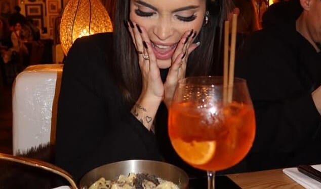 A woman poses up a storm as she enjoys an Italian dinner at one of the Big Mamma restaurants in London