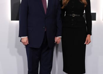 The First Lady donned a buttoned black dress and stilettos as she was joined by her husband who wore his signature navy blue suit