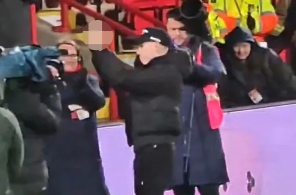 James McClean gives rival fans an X-rated gesture at a football match.