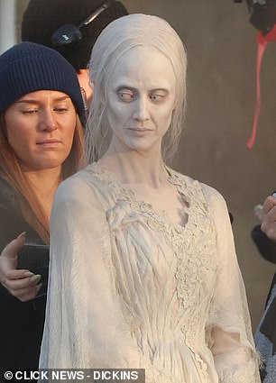 The actor was seen shivering and laughing between takes with his co-star, Andrea Riseborough (pictured)