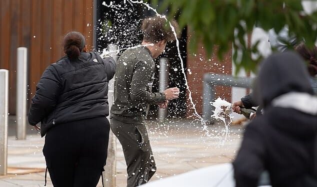 People spray sparkling wine over a man who walked out of Nottingham Prison on September 10, 2024 - the day the early release scheme came into effect