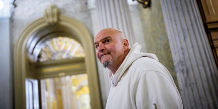 Sen. John Fetterman, one of eight Democrats to say he will vote with Republicans to open the government, arrives for votes on Nov. 10, 2025, on Capitol Hill in Washington, D.C.