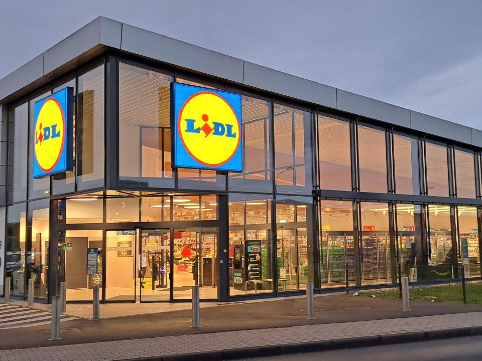 Exterior of a modern Lidl supermarket in Weilerswist, Germany, at dusk.
